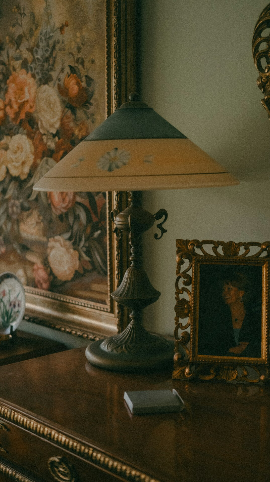 Close-up of a curated vintage interior vignette with lamp and books